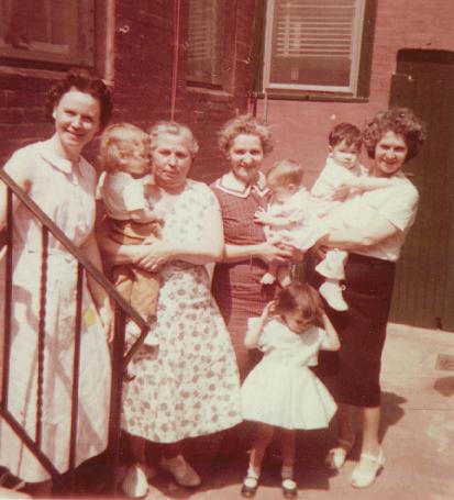 From left to right: Mabel, Carol, Marie, Helen holding Robert with Suzanne below, and Margaret holding Drew. Marie and Margaret are sisters & Helen is their sister-in-law. Marie is holding her granddaughter Carol, Mabel's daughter. Helen is holding her grandchildren, and Margaret is holding her grandson (my brother). Photo date - around spring of 1960.