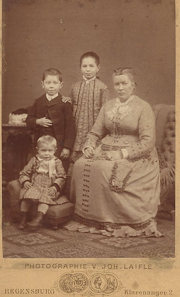 Ursula with her children Hilaury, Joseph (standing), and Ignatz. Taken in Regensburg, Germany, in approximately 1879-80.